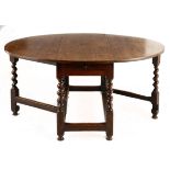 AN OAK GATELEG TABLE, 17th CENTURY the oval top with hinged drop sides above a plain frieze, on