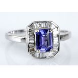 A TANZANITE AND DIAMOND RING centred with an emerald-cut tanzanite weighing approximately 0.79cts,