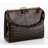 A GOLDPFEIL LEATHER CROCODILE HANDBAG Dark brown crocodile bag with gold hardware clasp. Lined in