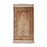 A HEREKE SILK PRAYER RUG, TURKEY, MODERN the ivory “mehrab” with a ascending tree design, twin