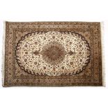A TURKISH CARPET, MODERN the ivory field with a beige floral round medallion, similar spandrels