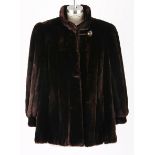 A CHOCOLATE BROWN SHEARED BEAVER COAT A gorgeous, lush fur coat with knit panel detail. Fully