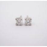 A PAIR OF DIAMOND EAR STUDS each claw set with a brilliant-cut diamond weighing approximately 0.