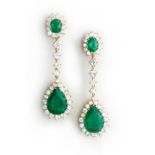 A PAIR OF EMERALD AND DIAMOND PENDENT EARRINGS each designed as a claw-set oval mixed-cut emerald