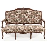 A FRENCH WALNUT AND UPHOLSTERED SETTEE, LATE 19TH CENTURY the floral carved padded back centred by a