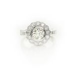 A DIAMOND RING designed as a flower-head cluster centred with a brilliant-cut diamond weighing 1.