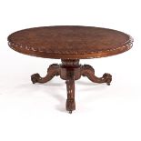 A VICTORIAN BURR WALNUT CENTRE TABLE the quarter-veneered tilt-top with a carved edge above a