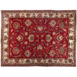 A TABRIZ CARPET, PERSIA, MODERN the red field with an overall design of bold palmettes and vines