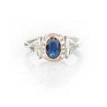 A SAPPHIRE AND DIAMOND RING centred with an oval mixed-cut sapphire weighing approximately 1.0ct,