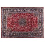 A KESHAN CARPET, PERSIA, MODERN the red field with a blue floral star medallion, similar