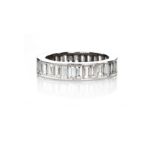 A DIAMOND ETERNITY RING channel set throughout with baguette-cut diamonds weighing approximately 3.