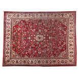 A SAROUK CARPET, PERSIA, MODERN the red field with a small ivory floral medallion, similar