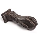 A CAST-IRON DOOR KNOCKER, A.K. & SONS, 19TH CENTURY modelled in the form of a hand holding a ball,