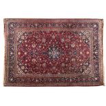 A KESHAN CARPET, PERSIA, MODERN the red field with a dark and sky-blue floral medallion, similar