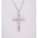 A DIAMOND PENDANT in the form of a Latin cross, claw set with brilliant-cut diamonds weighing