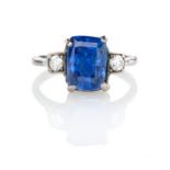 A SAPPHIRE AND DIAMOND RING centred with a cushion-shaped mixed-cut sapphire weighing