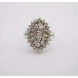 A DIAMOND RING designed as a navette-shaped cluster, claw set with brilliant-cut diamonds weighing