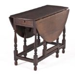 AN OAK GATE-LEG TABLE, 19TH CENTURY the oval top with hinged drop sides above a plain frieze,