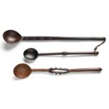 TWO ZULU WOODEN SPOONS each handle carved in geometric patterns, the larger 39,5cm long; and