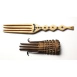 A ZULU BONE HAIR COMB the handle shaped and decorated with circular patterns 18cm long; and Another,
