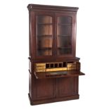 A VICTORIAN MAHOGANY SÉCRETAIRE BOOKCASE in two parts, the outswept moulded cornice above a plain