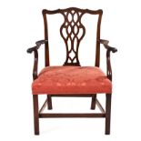 A GEORGE III STYLE MAHOGANY SIDE CHAIR the shaped top rail above a carved and pierced splat, drop-in