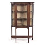 AN EDWARDIAN MAHOGANY DISPLAY CABINET the shaped and moulded cornice above a plain frieze, a