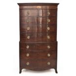 A GEORGE III FLAME MAHOGANY BOWFRONTED CHEST-ON-CHEST in two parts, the moulded pediment above a