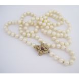A SINGLE-STRAND PEARL NECKLACE opera length, composed of one hundred and fourteen pearls,