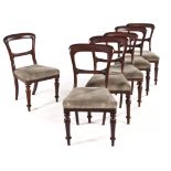 A SET OF SIX VICTORIAN MAHOGANY SIDE CHAIRS each curved top rail above a carved mid-rail, stuff-over