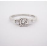 A DIAMOND RING centred with a claw-set brilliant-cut diamond weighing approximately 0.5cts,