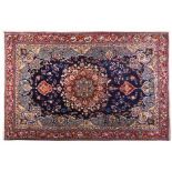 A MESHED CARPET, EAST PERSIA, MODERN the dark indigo-blue field with a bold red and blue floral