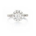 A DIAMOND RING designed as a flower-head cluster, centred with a brilliant-cut diamond weighing 1.