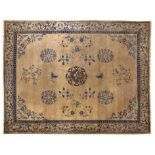 A CHINESE CARPET, CIRCA 1920 the gold field with a round blue medallion with a dragon in the centre,