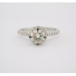 A DIAMOND RING claw set to the centre with a round brilliant-cut diamond weighing 0.5020cts, the