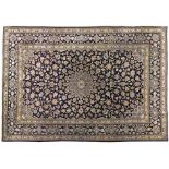 A KESHAN CARPET, PERSIA, MODERN the indigo-blue field with a pale blue floral star medallion,