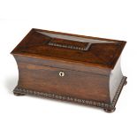 A GEORGE III ROSEWOOD TEA CADDY the sarcophagus-shaped hinged lid centred by a rectangular vacant