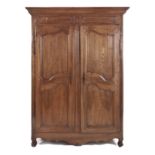 A FRENCH PROVENÇAL LOUIS XV STYLE WALNUT ARMOIRE the later outset cornice above a carved frieze