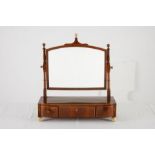 A GEORGE III FLAME MAHOGANY GENTLEMAN'S MIRROR the oval moulded plate within a conforming frame