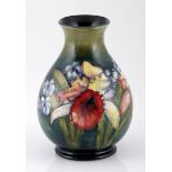 A MOORCROFT 'ORCHID' PATTERN VASE, MID 20TH CENTURY the tapering ovoid body, tube-lined with orchids