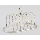 A SILVER TOAST RACK the oval frame with arched partitions, centred with a ring handle, 164g, 11,