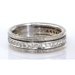 A DIAMOND ETERNITY RING channel-set with brilliant-cut diamonds weighing approximately 0.72cts in