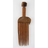 A CHOKWE COMB, ANGOLA the handle carved as female mask with elaborate coiffure 20cm high
