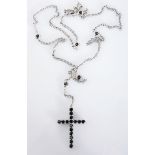 A BLACK DIAMOND CROSS PENDANT of rosary style, claw-set with circular-cut black diamonds weighing