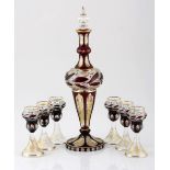 A BOHEMIAN RED STAINED, ENGRAVED AND GILT LIQUEUR SET, 19TH CENTURY each cut with various shaped