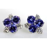 A PAIR OF TANZANITE AND DIAMOND EAR STUDS each designed as a cluster, claw-set with circular