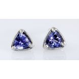 A PAIR OF TANZANITE EAR STUDS each claw- and bezel-set with a trillion-cut tanzanite weighing