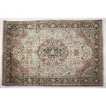 AN INDO PERSIAN SILK RUG, MODERN the ivory field with a floral cinnamon and blue medallion,