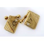 A PAIR OF 9CT GOLD CUFFLINKS each with a rectangular form, with a textured plaque applied with a
