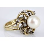 A PEARL AND DIAMOND RING centred with a cultured pearl, measuring approximately 8.7mm diameter,